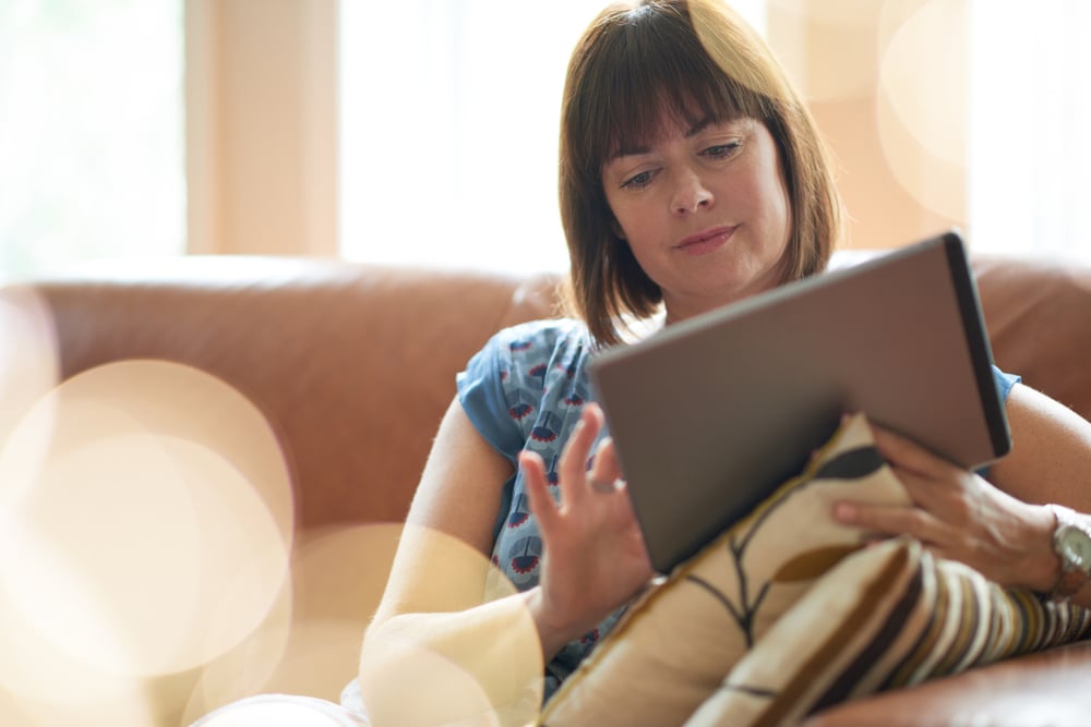 Mature woman browsing the internet on a digital tablet-1